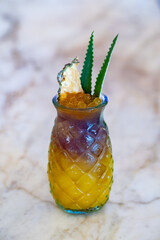 Pineapple and Boba Tea cocktail with pineapple and agave garnish