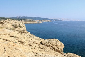 Fototapeta na wymiar The blue sea and sandstone coast of Lopar on the island Rab, Croatia