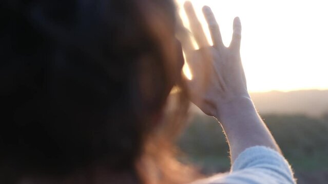 A human hand reaches out, embracing the warmth of sunlight, symbolizing connection, hope, and the beauty of life.