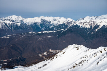peaks of snow-capped mountains in winter - 766361295