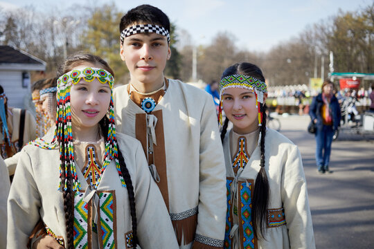  Three yakuts people in national folk clothes at park.