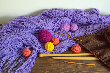 Knitting and hobby concept. Multicolored balls of wools, unfinished knitting,  knitting  needles...