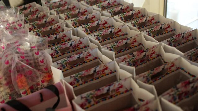 gift bags are lined up on the table at the holiday