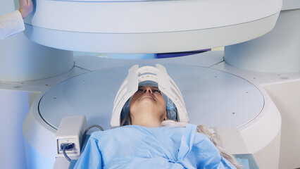 Magnetic resonance imaging in the study of the human body. A doctor performs an MRI on a patient in...