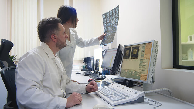 In a medical laboratory, the patient undergoes an MRI or CT scan under the supervision of radiologists; In the control room, doctors monitor the progress of the procedure 