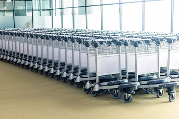 Many empty luggage trolleys at the airport.