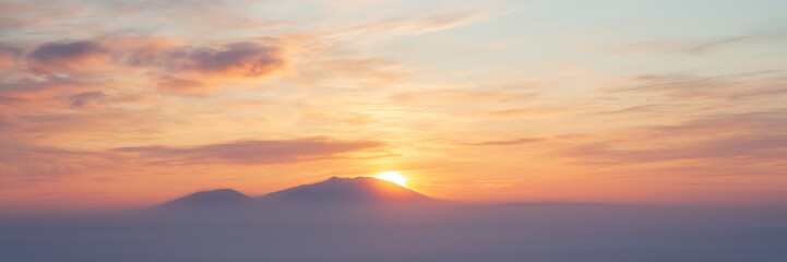 Winter arctic landscape. Cold winter weather. Frosty fog over the winter tundra. Sunset over the...