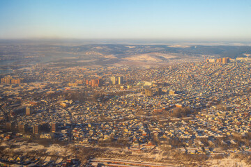 Top view of the city of Irkutsk, Irkutsk region, Siberia, Russia. Aerial photograph of low-rise buildings on the outskirts of a large Siberian city. View from above of buildings and city streets.