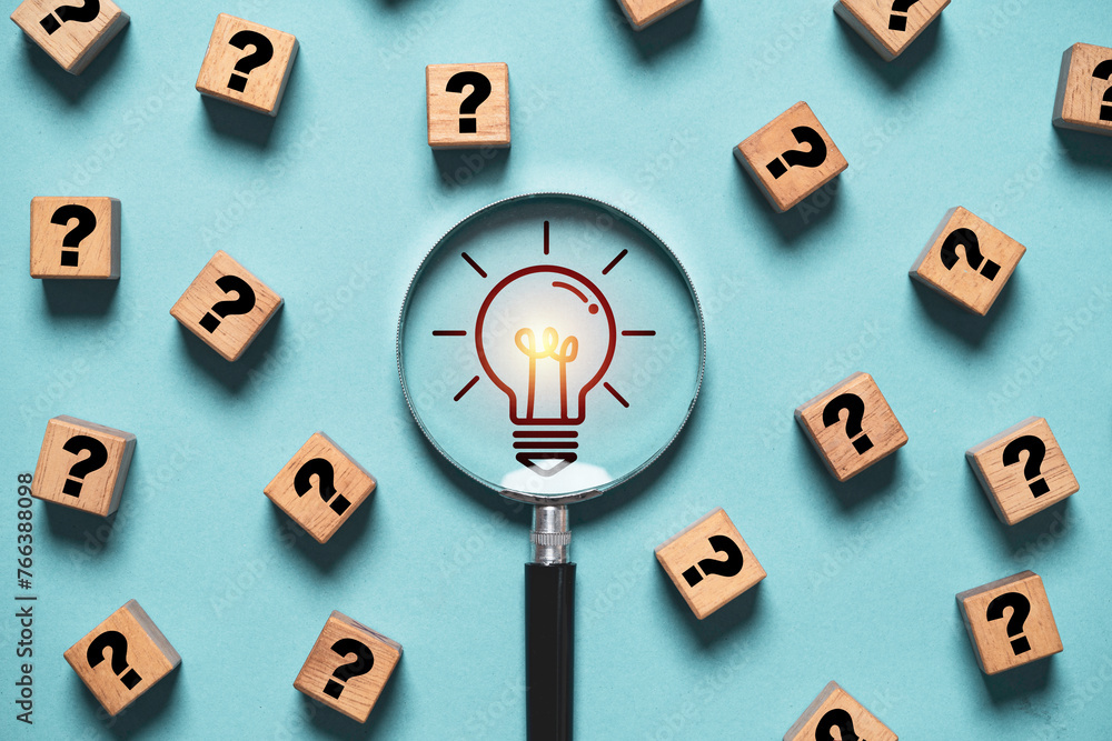 Poster glowing light bulb inside magnifier glass among question mark for focus and concentrate of creative 