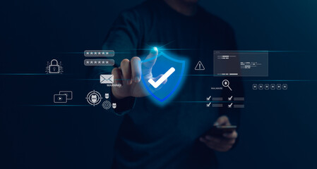 A person is touching a blue shield on a computer screen