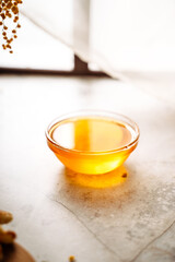 honey in a glass cup on the table, close-up