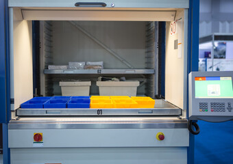 Vertical storage ergonomic solution. Automated storage and retrieval system. Modern industrial warehouse.