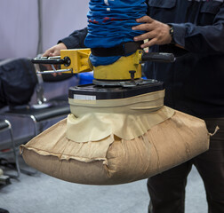 Worker use vacuum tube lifter moving sack.