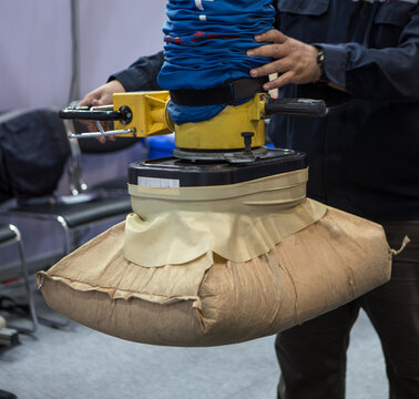Worker use vacuum tube lifter moving sack.