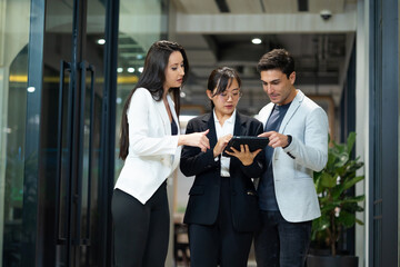 Business meeting - Meeting and talk about work while walking in the office hall. Group of friends meeting at home. Diverse business people asian woman and caucasian man discussion