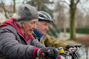 Pensioners on a bicycle ride, using a GPS navigator for the route