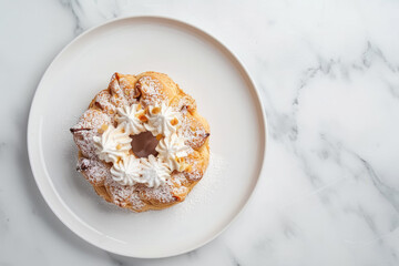 overhead view of paris brest pastry on white plate