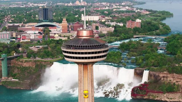 Aerial Panning Shot Of Skylon Tower Observation Tower Over Niagara River In City - Niagara Falls, Canada