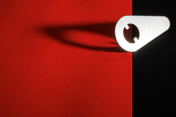 A metalic block and its shadow at the red and textured black background for web and graphic design use