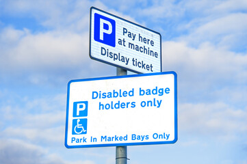 Fototapeta premium Disabled blue badge holder parking sign for driver 