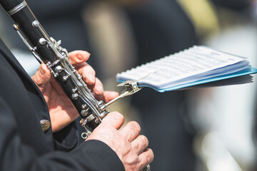 Details of hands playing the clarinet