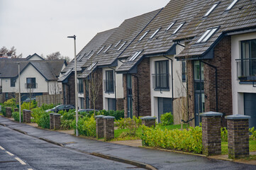 Fototapeta na wymiar New homes in a row at recently completed housing development