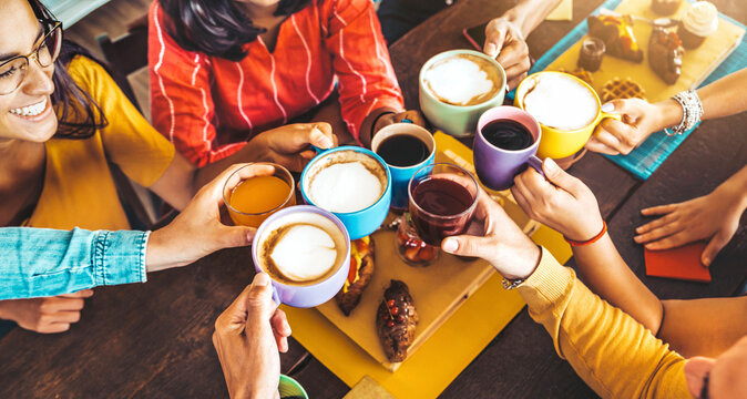 Group of people having fresh healthy breakfast sitting at bar table - Happy friends drinking cappuccino at cafe house open space - Food and beverage life style concept - Powered by Adobe