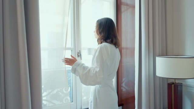 Woman with Coffee by Hotel Window