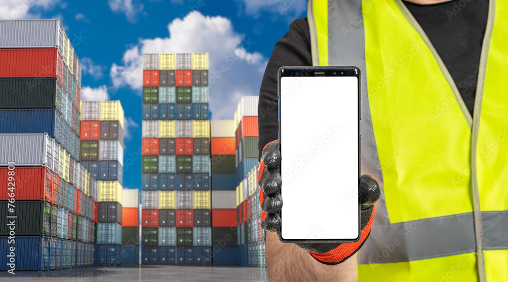 Poster container site. phone is in hand of port worker. warehouse of sea containers in harbor. smartphone w