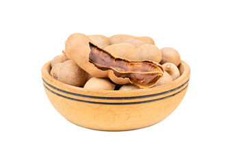 Tamarind fruit in wooden bowl isolated on white background