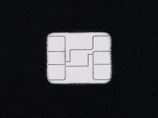Credit card security chip close up on a black card