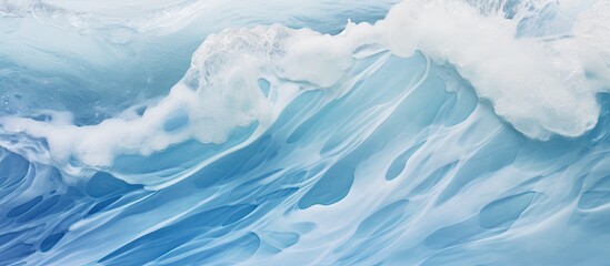 Wave breaking on the sandy shore with a clear blue sky in the background, creating a beautiful coastal scene