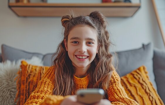 Adorable teenage girl speaking over a modern smartphone webcam. The idea of online communication