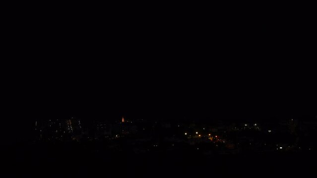 Timelapse of nighfall over coast and Alcossebre seaside village. View from the Hermitage of Saint Lucia. Valencian Community, Costa del Azahar, Spain.