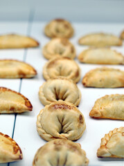 Typical Argentine puff pastry empanadas filled and baked
