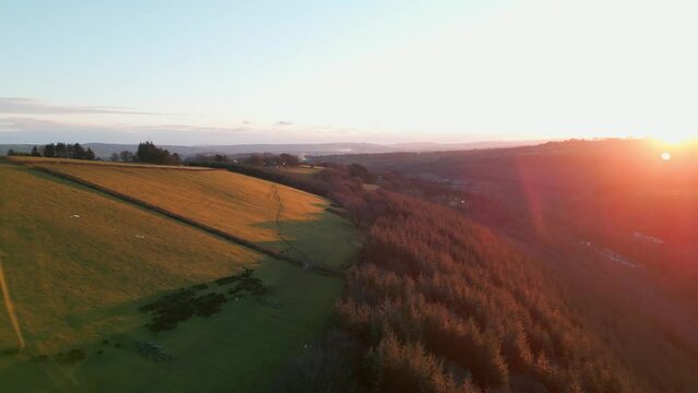 Drone footage of welsh landscape farmers field during sunset in the valleys south wales