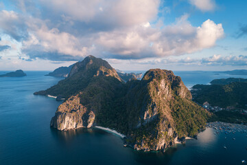 Aerial view of beach, sea and mountain on sunset. El Nido, Palawan. Tropical landscape hill,...