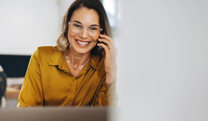 The call of success: Business woman making connections over the phone