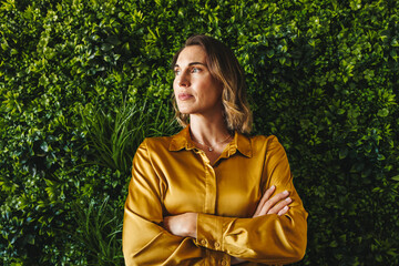 Green office goals: A successful businesswoman contemplates eco-friendly strategies