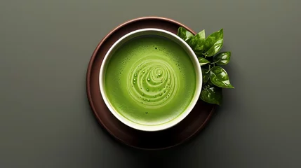 Schilderijen op glas A cup filled with green tea matcha, topped with vibrant green tea leaves. © Виктория Лапина