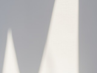 white wall illuminated by strong sunlight with shadows