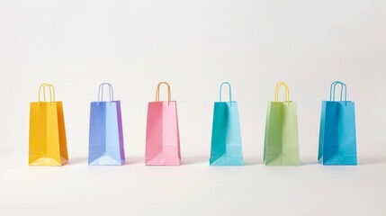 Brightly colored paper shopping bags standing alone on a white background.