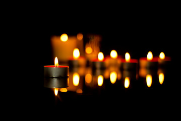 The flickering lights of candles in memory of the deceased In the silence of the darkness of the...