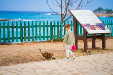 Portrait of a child with cat in cyprus on the beach 