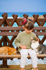 Portrait of a child with cat in cyprus on the beach 