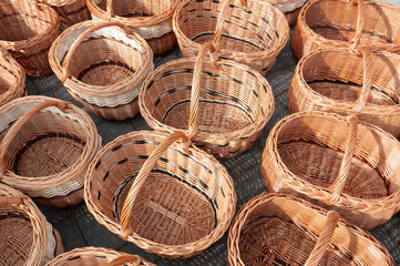 Cestas de mimbre artesanas fabricadas a mano en un puesto de artesan&iacute;a de una feria o mercado.