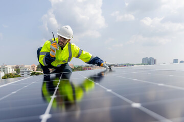 Engineer service check installation solar cell on the roof of factory. Engineers walking on roof inspect and check solar cell panel. Engineer working inspection installation solar cell on the roof