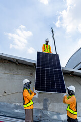 Technicians Install photovoltaic solar modules on roof of factory. Engineers install or fix solar...