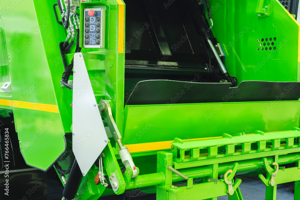 Aufkleber A modern machine for transporting waste waste with a press and automatic loading and unloading, rear view of the mechanization and trash can