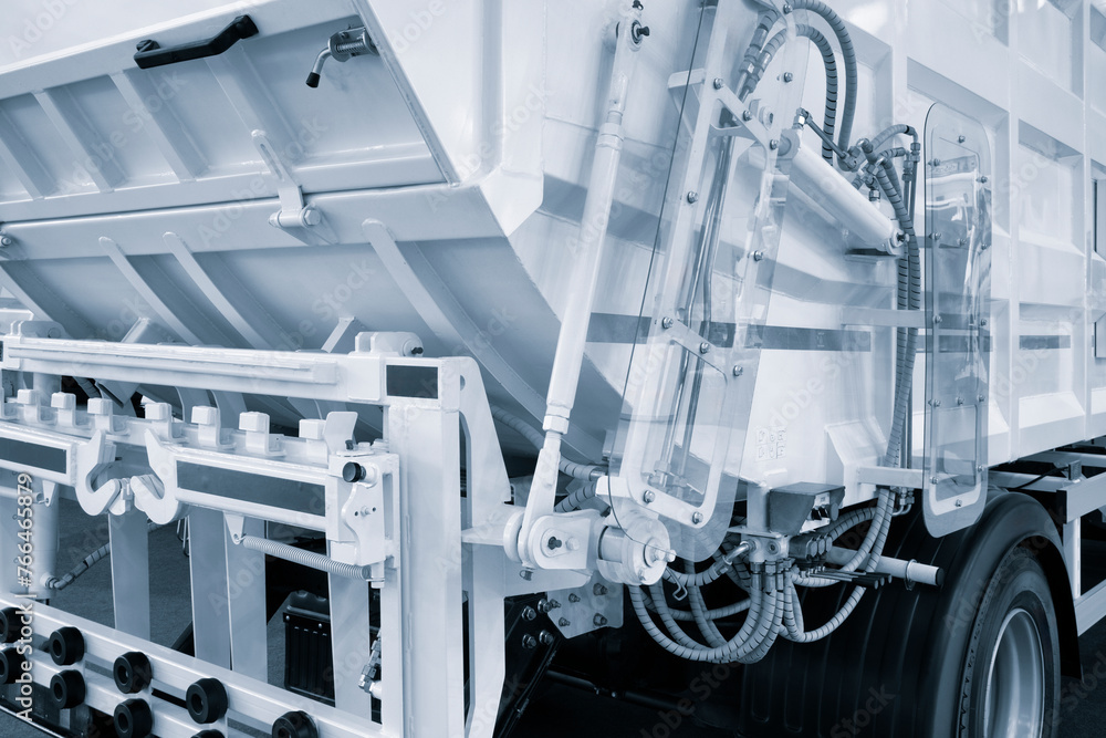 Poster A modern machine for transporting waste waste with a press and automatic loading and unloading, rear view of the mechanization and trash can